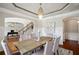 Elegant dining room with chandelier, tray ceiling, and hardwood floors at 3345 Palmer Lake Pointe, Douglasville, GA 30135