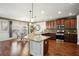 Well-lit kitchen featuring stainless steel appliances, granite countertops, wooden cabinets, and an adjacent dining area at 3345 Palmer Lake Pointe, Douglasville, GA 30135
