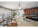 Modern kitchen featuring stainless steel appliances, granite countertops, wooden cabinets and an adjacent dining area at 3345 Palmer Lake Pointe, Douglasville, GA 30135