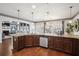 Well-lit kitchen with granite countertops, an island sink, wooden cabinets, stainless steel appliances and hardwood floors at 3345 Palmer Lake Pointe, Douglasville, GA 30135