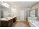 Bright bathroom featuring a large tub, a stand-up shower, and double sinks at 3345 Palmer Lake Pointe, Douglasville, GA 30135