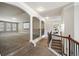 A carpeted upstairs hallway features detailed wood and wrought iron railings, and arched entryways to other rooms at 3345 Palmer Lake Pointe, Douglasville, GA 30135