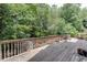 A spacious back deck surrounded by lush trees at 380 Chandler Ct, Sugar Hill, GA 30518