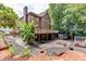 A backyard with a raised deck, patio, firepit, and landscaping at 380 Chandler Ct, Sugar Hill, GA 30518