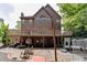 Home backyard featuring a spacious deck, patio, and mature trees at 380 Chandler Ct, Sugar Hill, GA 30518