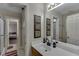 Well-lit bathroom showcasing a single sink vanity and an adjacent shower area at 380 Chandler Ct, Sugar Hill, GA 30518