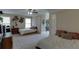 Spacious bedroom showcasing two beds with neutral walls, plush carpet, and a ceiling fan at 380 Chandler Ct, Sugar Hill, GA 30518