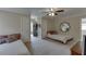 Bright, open bedroom with twin beds, neutral walls, plush carpet, and a ceiling fan at 380 Chandler Ct, Sugar Hill, GA 30518