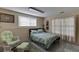 Cozy bedroom showcasing a bed, soft chair, and window with light-filtering curtains at 380 Chandler Ct, Sugar Hill, GA 30518