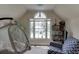 Cozy bonus room with large window and a comfortable reading nook at 380 Chandler Ct, Sugar Hill, GA 30518