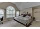 Vaulted ceilings highlight this primary bedroom with decorative window features, a patterned carpet, and natural lighting at 380 Chandler Ct, Sugar Hill, GA 30518