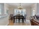 Bright dining room with hardwood floors, elegant chandelier, and natural light at 380 Chandler Ct, Sugar Hill, GA 30518