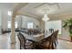 Elegant dining room featuring a large dining table, chandelier, and an open view into the living area at 380 Chandler Ct, Sugar Hill, GA 30518