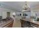Open dining area with chandelier, seamlessly connected to the modern kitchen at 380 Chandler Ct, Sugar Hill, GA 30518