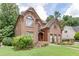 Charming two-story brick home with a well-maintained lawn and inviting landscaping, perfect for curb appeal at 380 Chandler Ct, Sugar Hill, GA 30518