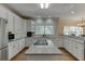 Bright kitchen with stainless steel appliances, white cabinets and central island cooktop at 380 Chandler Ct, Sugar Hill, GA 30518