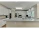 Bright kitchen with granite countertops, white cabinets, and stainless steel appliances at 380 Chandler Ct, Sugar Hill, GA 30518