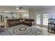 Spacious living area with kitchen, hardwood floors, large windows, and comfortable seating at 380 Chandler Ct, Sugar Hill, GA 30518