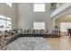 Spacious living room featuring high ceilings, large windows, and a comfortable sectional sofa at 380 Chandler Ct, Sugar Hill, GA 30518