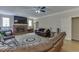 Bright living room featuring a brick fireplace, ceiling fan, and hardwood floors at 380 Chandler Ct, Sugar Hill, GA 30518