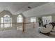 Upper level area with decorative lighting, large windows, and a comfortable massage chair at 380 Chandler Ct, Sugar Hill, GA 30518
