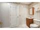 Bathroom featuring a white toilet and a vanity with a wood finish and a white sink at 426 College E St, Bowdon, GA 30108