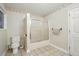 Neutral bathroom featuring tile flooring, standard toilet and shower with sliding glass doors at 426 College E St, Bowdon, GA 30108