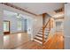 Open floor plan featuring hardwood floors, a staircase, and an open doorway to the living room at 426 College E St, Bowdon, GA 30108