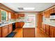 Open kitchen featuring wood cabinets, white countertops, island, and laminate flooring at 426 College E St, Bowdon, GA 30108