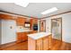 Kitchen featuring wood cabinets, white countertops, and island, adjacent to stairs at 426 College E St, Bowdon, GA 30108