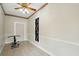 Extra room with tile flooring, paneled walls, and a decorative ceiling fan at 426 College E St, Bowdon, GA 30108