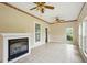 Cozy living area with tile floors, a decorative ceiling fan, and a modern fireplace at 426 College E St, Bowdon, GA 30108