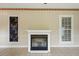 Bright living room featuring a modern fireplace, tile floors, and natural light at 426 College E St, Bowdon, GA 30108