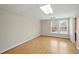Spacious living room boasting wood floors, neutral paint and trim plus one window at 426 College E St, Bowdon, GA 30108