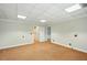Carpeted room with neutral walls featuring ample space, neutral carpet, and multiple entryways at 426 College E St, Bowdon, GA 30108