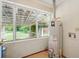 Utility room with views of back yard, featuring tile floors and a water heater at 426 College E St, Bowdon, GA 30108