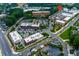 Aerial neighborhood view showing tree-lined streets, sidewalks, townhomes, shopping and parking at 451 Burton Dr # 32, Alpharetta, GA 30009