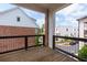 Balcony view of tree-lined street with neighboring townhomes, offering a vibrant community ambiance from a private perch at 451 Burton Dr # 32, Alpharetta, GA 30009