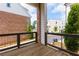 Balcony view showcases the neighborhood with its modern brick buildings and serene landscaped streets below at 451 Burton Dr # 32, Alpharetta, GA 30009
