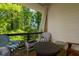 This tranquil balcony offers a peaceful retreat with a serene forest view and comfortable seating for enjoying nature's beauty at 451 Burton Dr # 32, Alpharetta, GA 30009