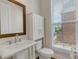 A bathroom features a vanity and a pedestal sink, complemented by a window for natural light at 451 Burton Dr # 32, Alpharetta, GA 30009