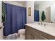 Bathroom features a sleek vanity with quartz countertops and a shower with a blue curtain at 451 Burton Dr # 32, Alpharetta, GA 30009