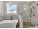 Bathroom featuring a modern soaking tub, a glass-enclosed shower, and elegant finishes creating a luxurious feel at 451 Burton Dr # 32, Alpharetta, GA 30009