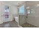 Bright bathroom featuring modern soaking tub, glass-enclosed shower, white tile, and access to private outdoor patio at 451 Burton Dr # 32, Alpharetta, GA 30009