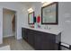 Bathroom features a double vanity with quartz countertops, modern fixtures and a walk-in shower at 451 Burton Dr # 32, Alpharetta, GA 30009