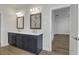 Bathroom featuring dual sinks with a gray vanity, wood-look tile flooring, and doorway leading to bedroom at 451 Burton Dr # 32, Alpharetta, GA 30009