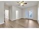 Bedroom featuring wood floors, a ceiling fan, natural light from windows, and glass door leading to balcony at 451 Burton Dr # 32, Alpharetta, GA 30009