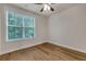A bright bedroom featuring hardwood floors and a window providing ample natural light at 451 Burton Dr # 32, Alpharetta, GA 30009
