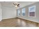 A bright bedroom with hardwood flooring and multiple bright windows for natural light at 451 Burton Dr # 32, Alpharetta, GA 30009