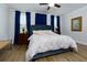 Primary bedroom features wood floors, blue accents and ample natural light at 451 Burton Dr # 32, Alpharetta, GA 30009